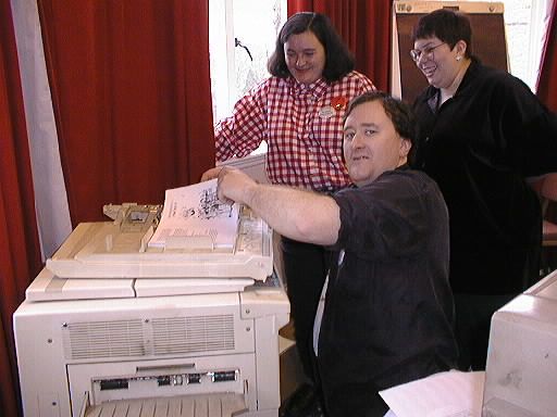 Noel Collyer prepares to deliver a baby photocopier. Bridget Hardcastle and Jo Mills watch.